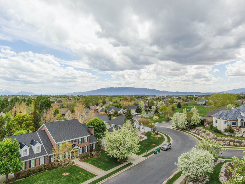 Aerial perspective of suburban area featuring a mountainous background