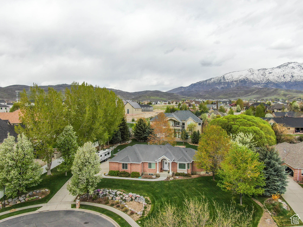 Aerial view of residential area featuring a mountainous background