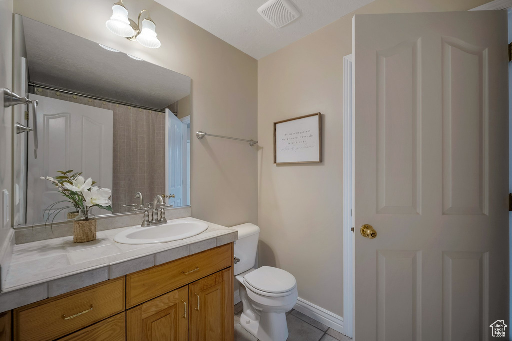 Full bath with vanity, toilet, tile patterned flooring, and a shower with curtain