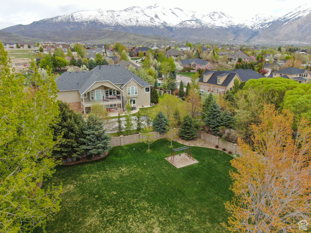 Aerial perspective of suburban area featuring a mountain backdrop