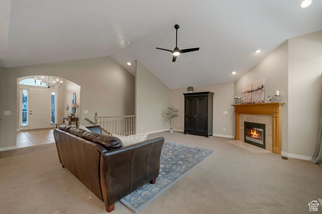 Living area with light colored carpet, vaulted ceiling, recessed lighting, a ceiling fan, and arched walkways
