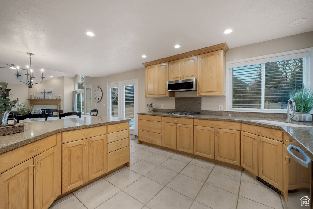 Kitchen featuring appliances with stainless steel finishes, a sink, light brown cabinets, healthy amount of natural light, and recessed lighting
