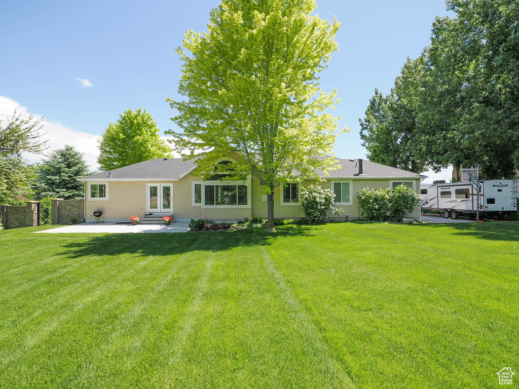 Rear view of house featuring a patio and stucco siding
