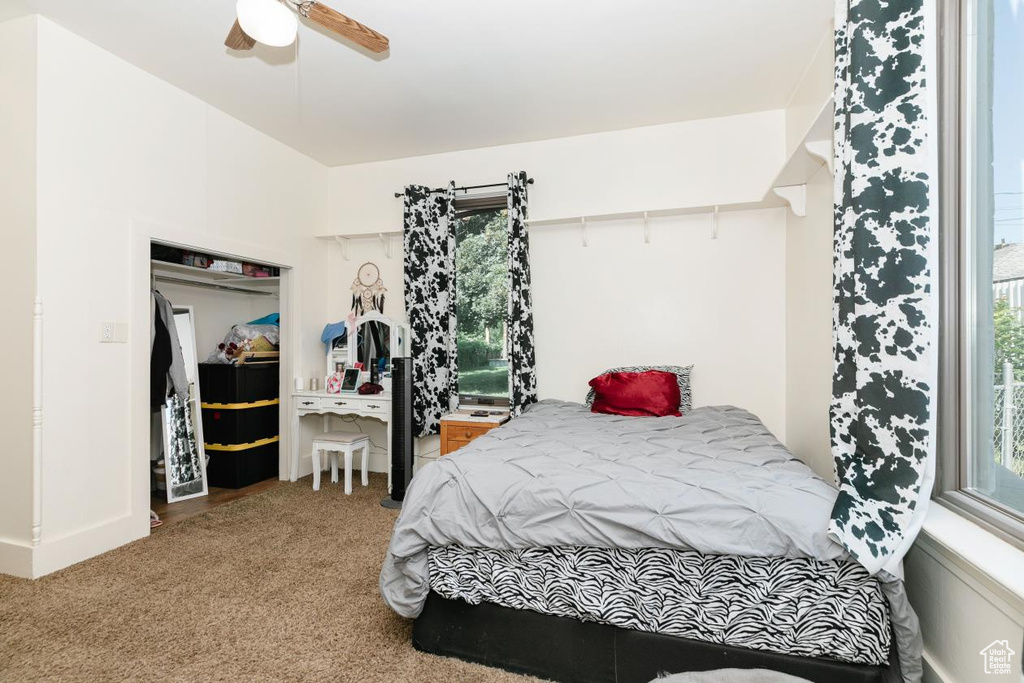 Bedroom featuring carpet, a ceiling fan, and baseboards