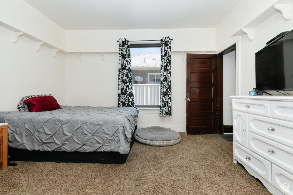 Bedroom featuring light carpet