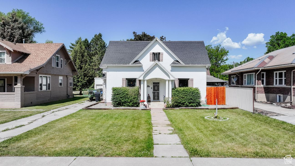 View of front of house with a shingled roof