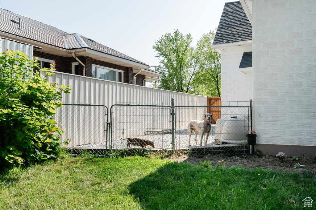 View of property exterior featuring a gate and brick siding
