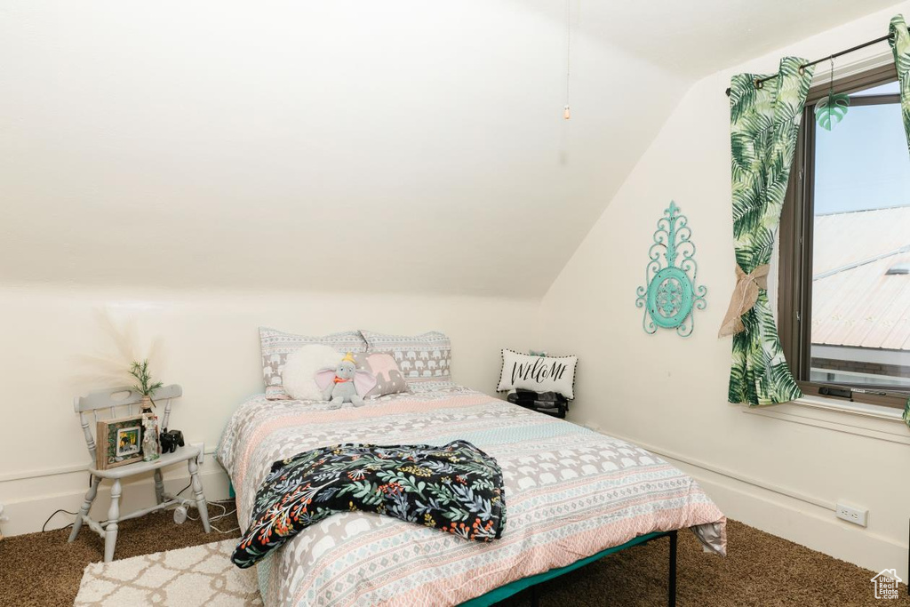 Carpeted bedroom with lofted ceiling