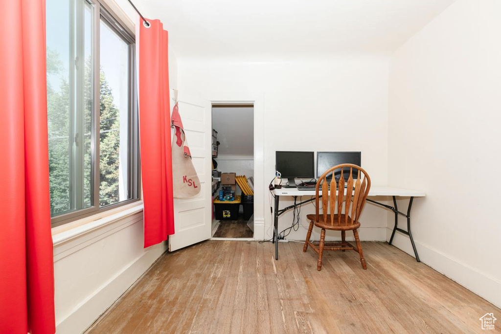 Office with wood finished floors and baseboards