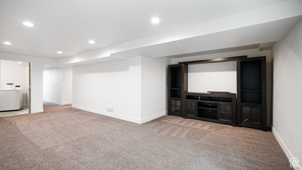 Finished basement featuring washer / clothes dryer, carpet flooring, recessed lighting, and baseboards