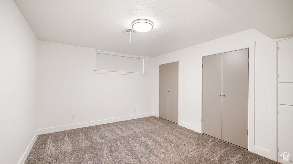 Unfurnished bedroom featuring carpet flooring and baseboards