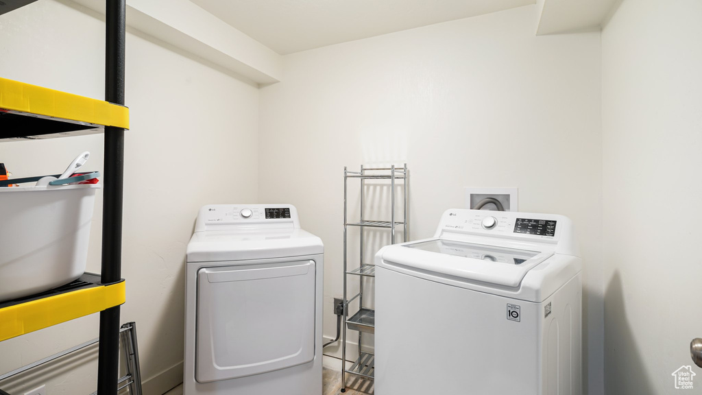 Laundry room with washing machine and clothes dryer