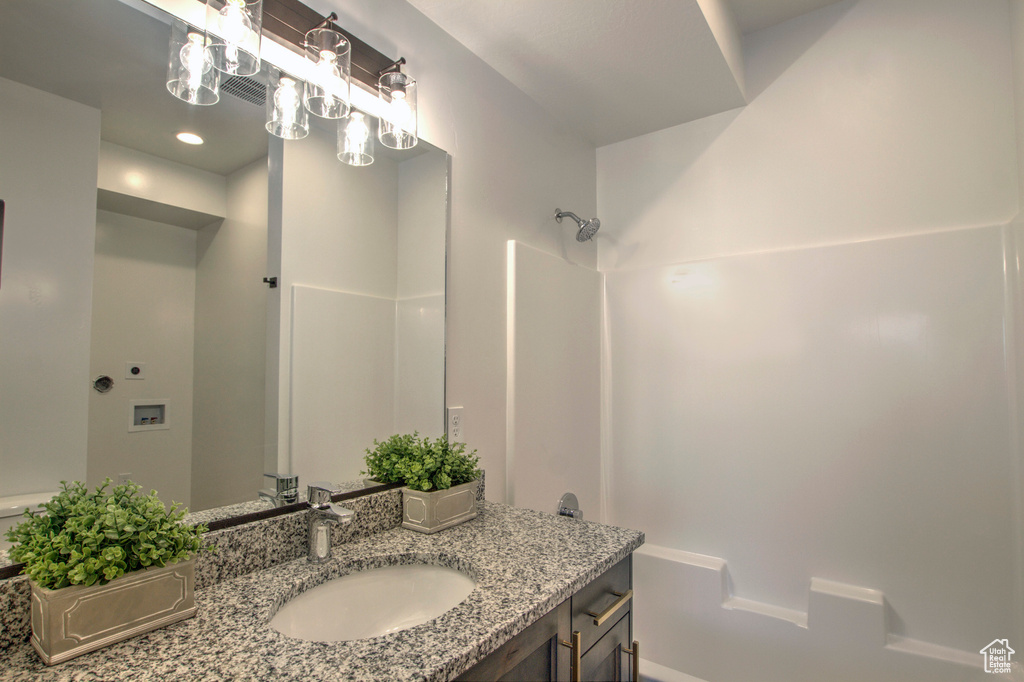 Bathroom featuring vanity and a shower
