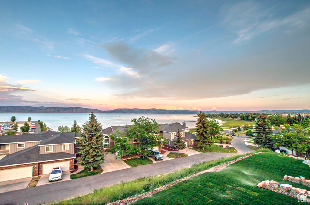 Aerial view at dusk of a water view and a residential view