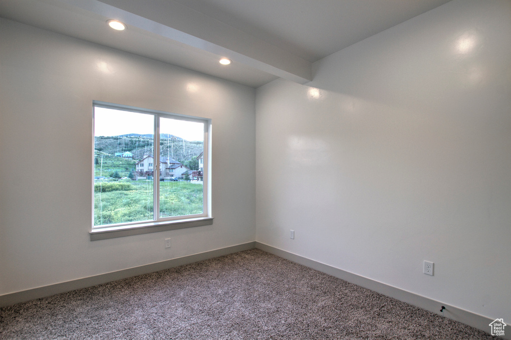Spare room featuring recessed lighting, carpet floors, and baseboards