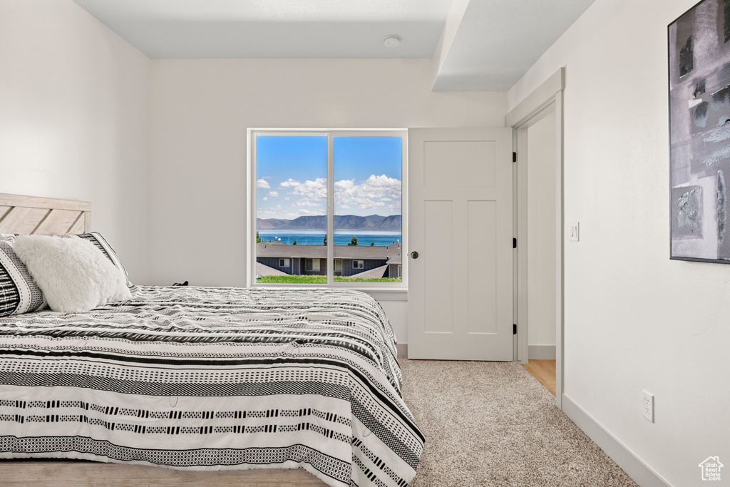 Bedroom featuring carpet flooring and baseboards