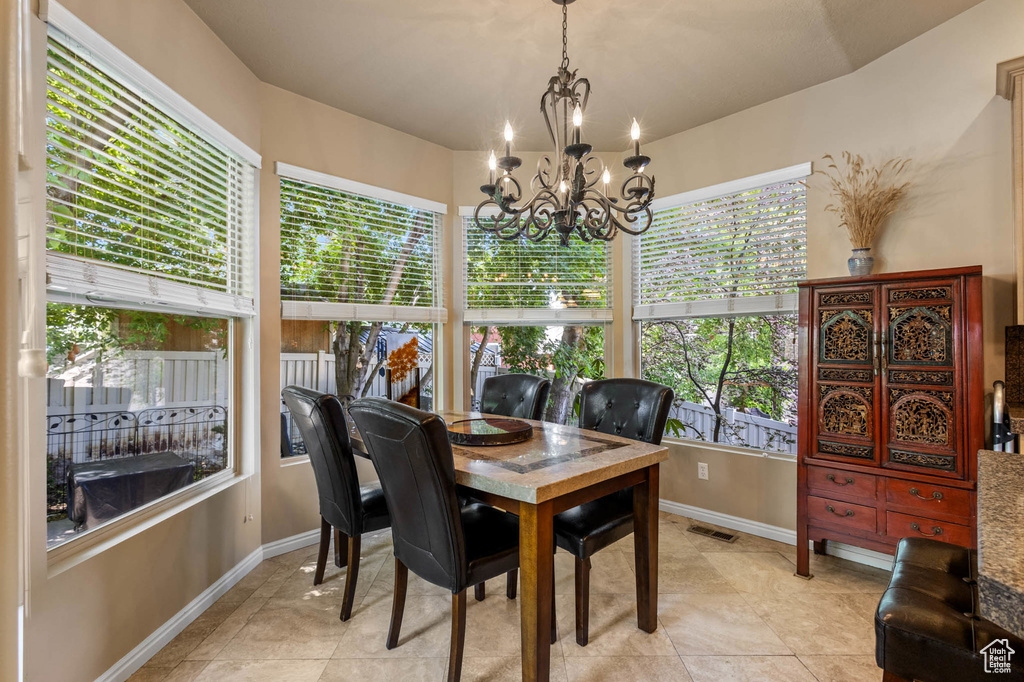 Dining area featuring healthy amount of natural light, baseboards, and light tile patterned floors