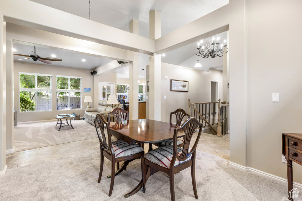 Dining space with light colored carpet, baseboards, ceiling fan, a chandelier, and recessed lighting