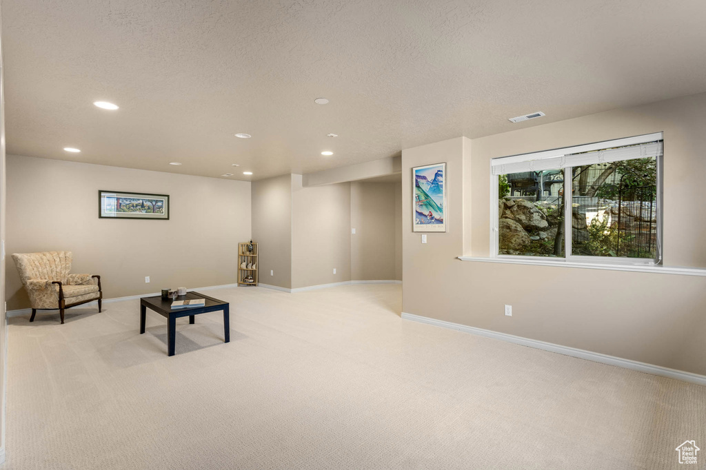 Unfurnished room with recessed lighting, light carpet, and baseboards
