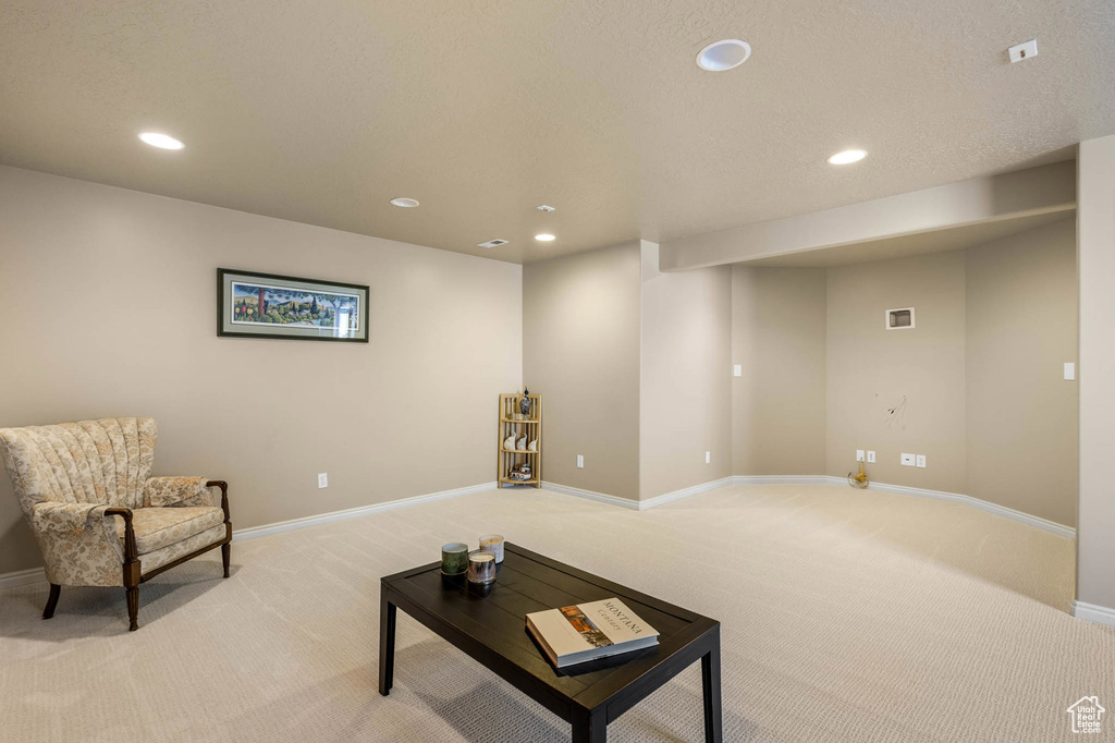 Living room featuring light carpet, recessed lighting, and baseboards