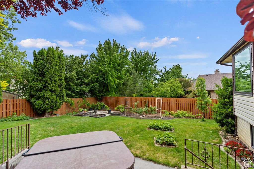 View of yard featuring a vegetable garden and a patio