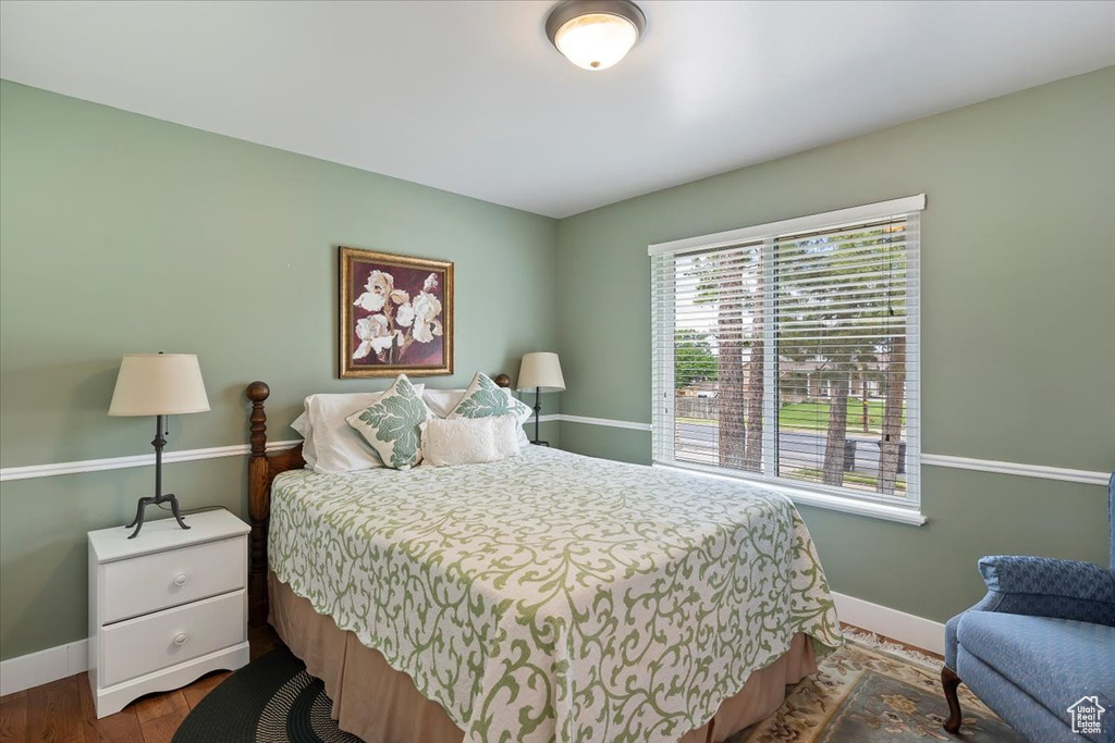 Bedroom featuring baseboards and wood finished floors