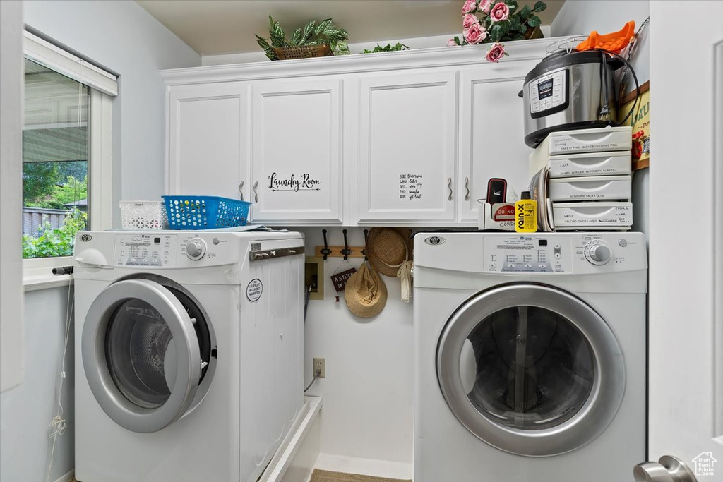 Laundry room featuring cabinet space and separate washer and dryer