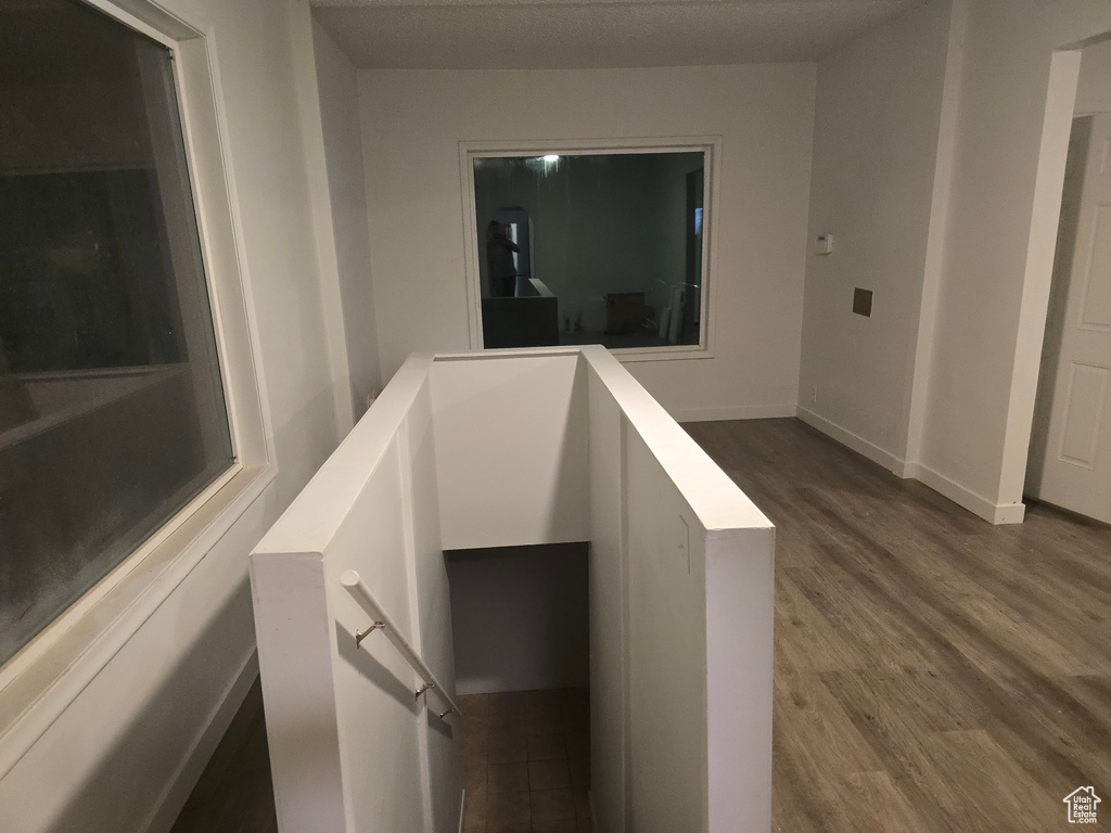 Stairway featuring wood finished floors and baseboards