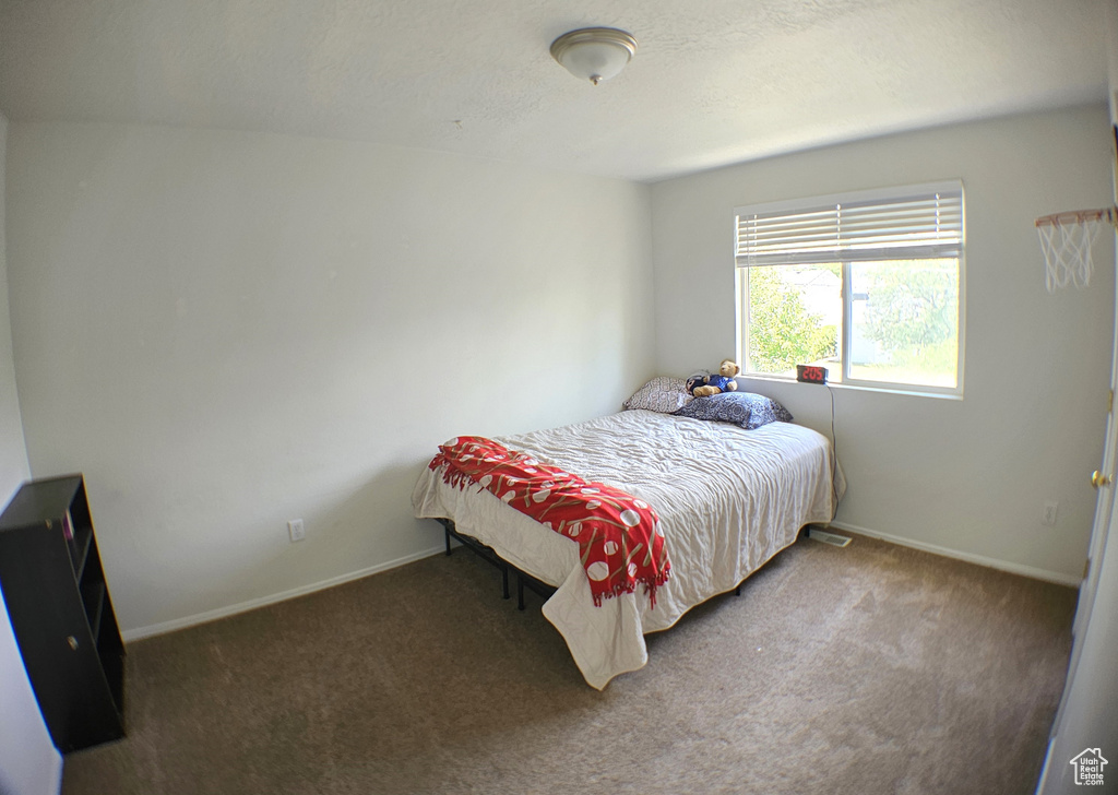 Carpeted bedroom featuring baseboards