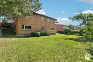 Rear view of house with a yard