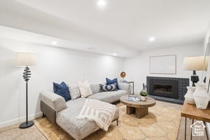 Living room featuring a fireplace, recessed lighting, and baseboards