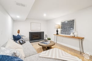 Living area featuring a fireplace, recessed lighting, and baseboards
