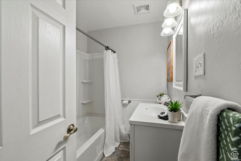 Bathroom featuring vanity and shower / tub combo with curtain