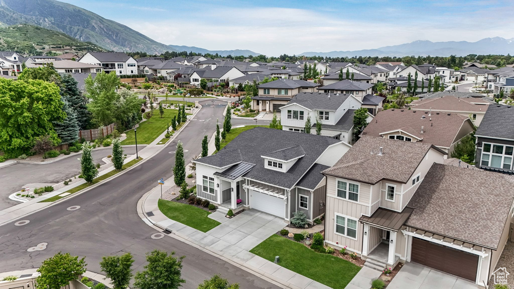 Aerial view of residential area featuring a mountainous background