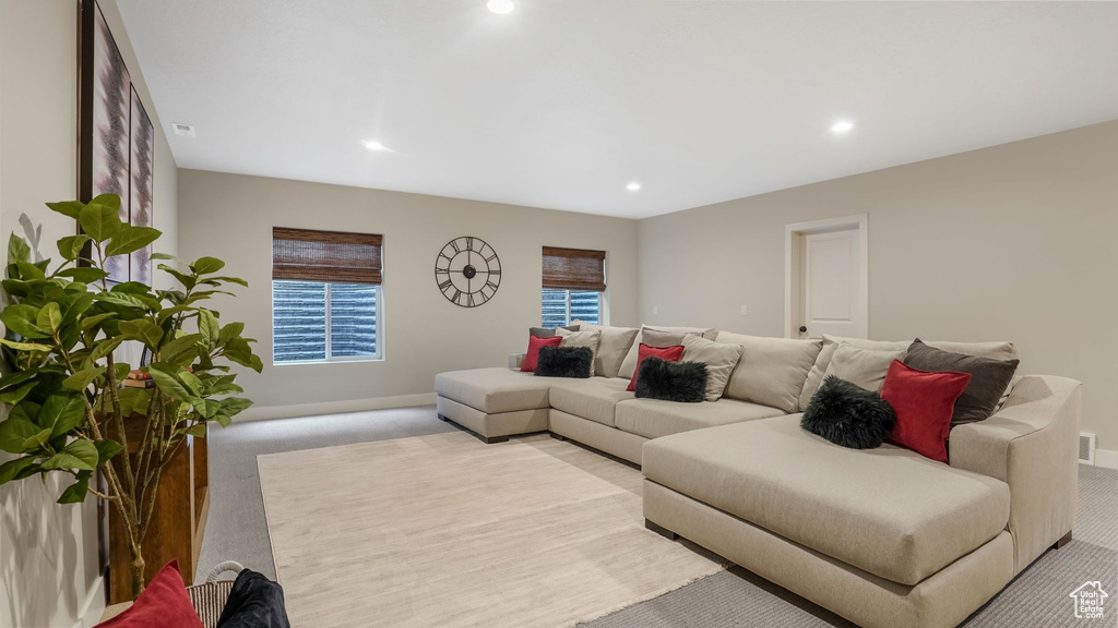 Living room with light carpet, recessed lighting, and baseboards