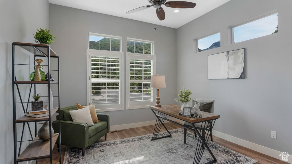Home office with a ceiling fan, wood finished floors, baseboards, and recessed lighting
