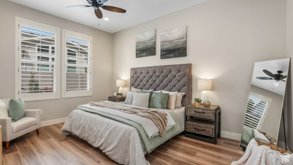 Bedroom with baseboards, wood finished floors, a ceiling fan, and recessed lighting