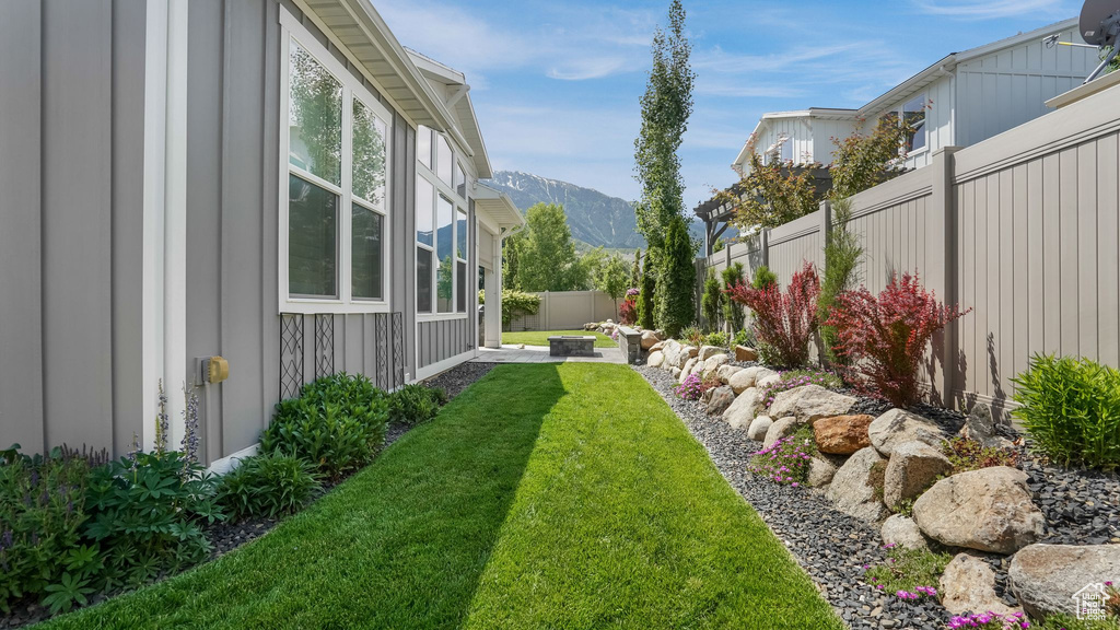 View of yard with a mountain view and a patio area
