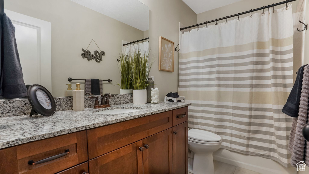 Full bathroom featuring vanity, toilet, and tile patterned flooring