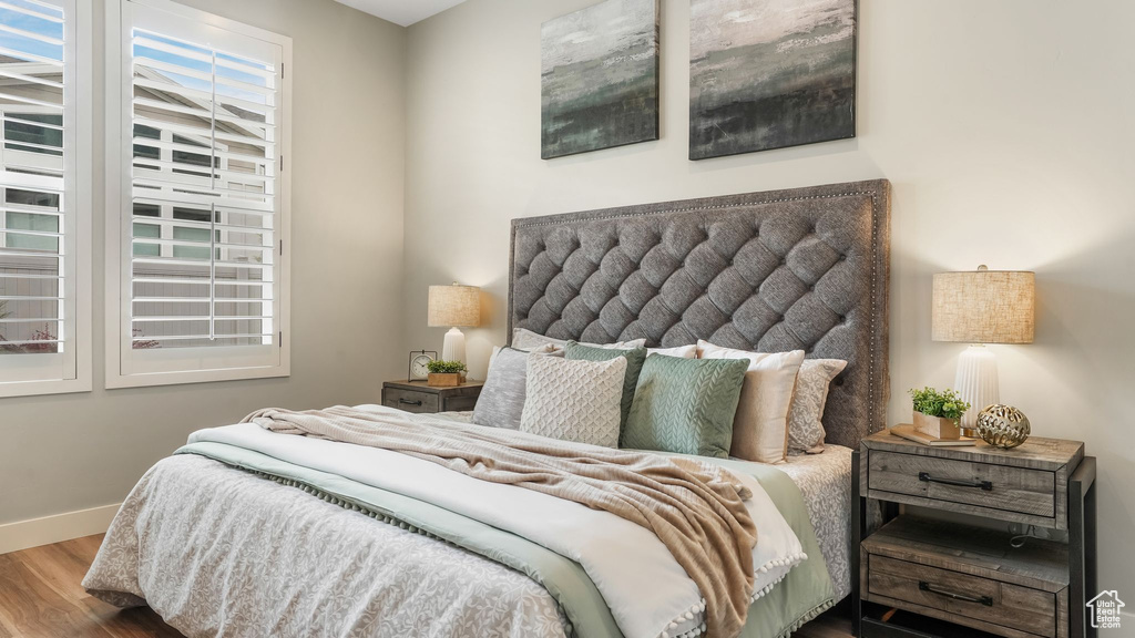 Bedroom featuring wood finished floors and baseboards