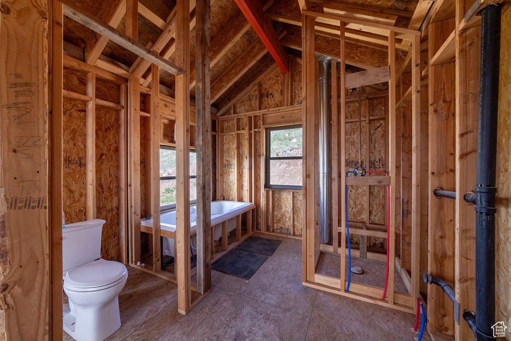 Bathroom with toilet and vaulted ceiling