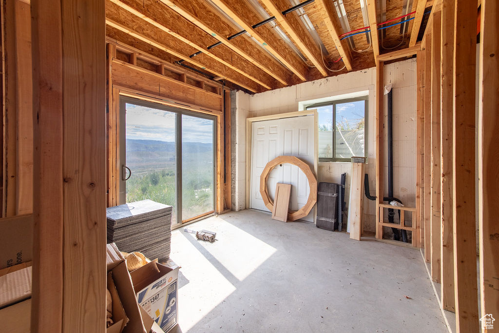 Misc room featuring healthy amount of natural light and unfinished concrete flooring