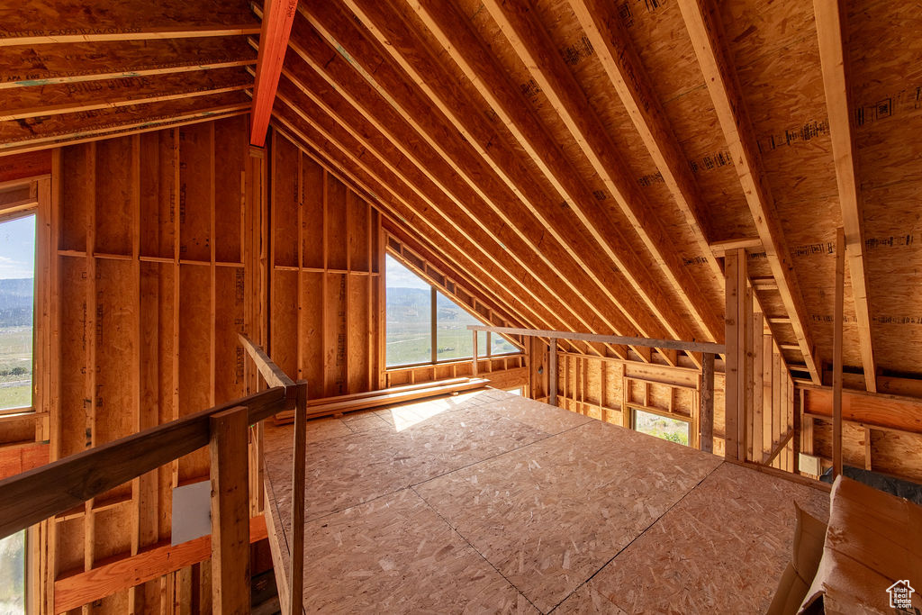 Unfinished attic with an upstairs landing