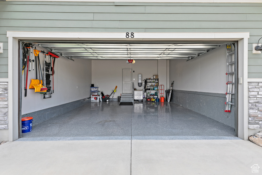 Garage featuring a central vacuum unit and a garage door opener