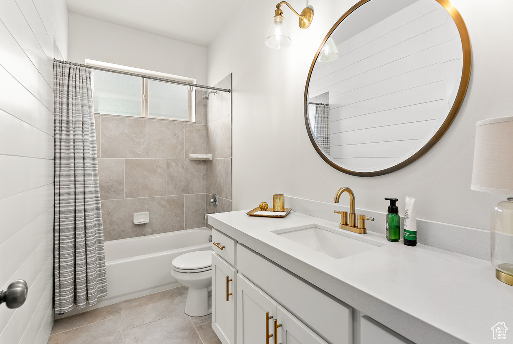 Bathroom with vanity, shower / bath combo, toilet, and tile patterned floors