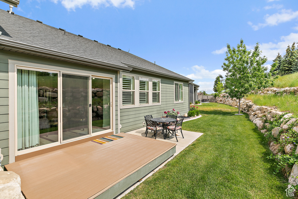 View of green lawn with a deck