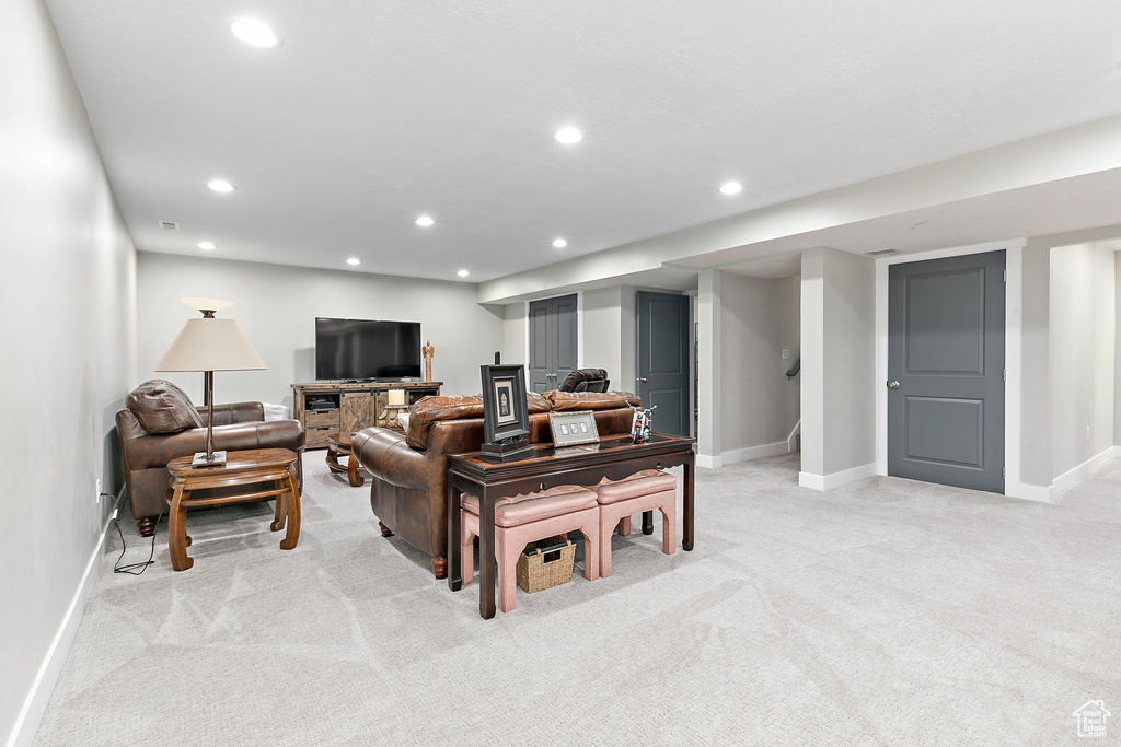 Living room featuring light colored carpet, recessed lighting, and baseboards