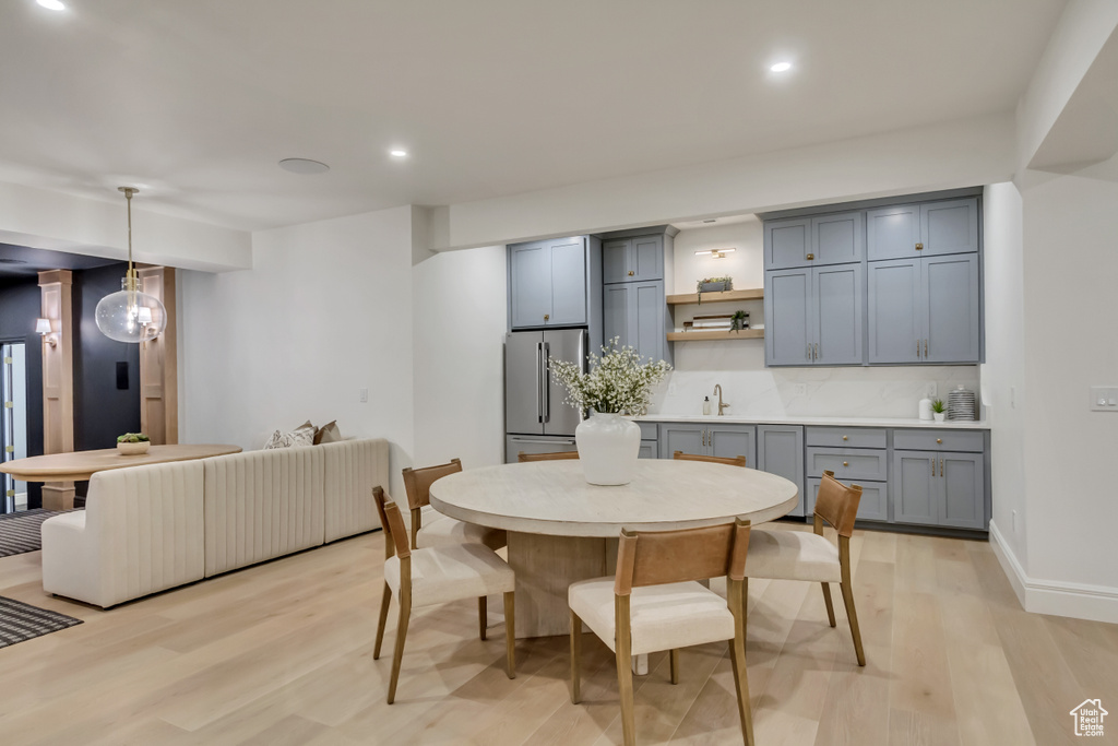 Dining room featuring light wood-style flooring and recessed lighting