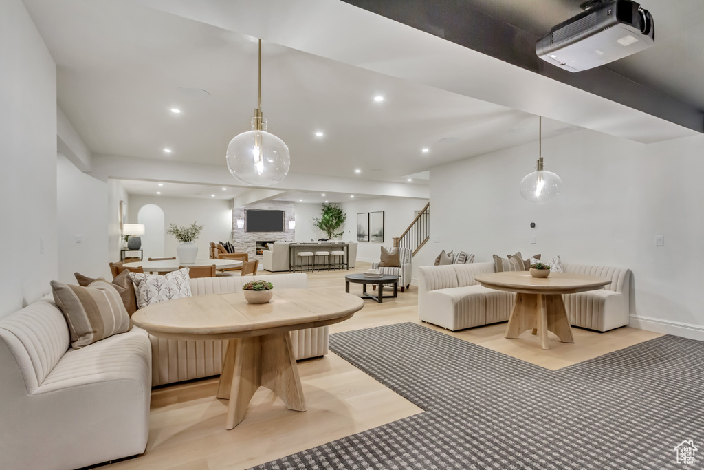 Living area with recessed lighting, stairway, and light wood-style floors