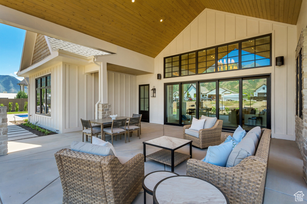 View of patio with an outdoor living space, outdoor dining space, and a mountain view